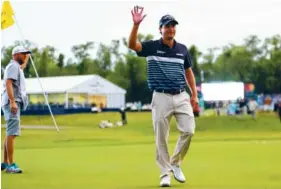  ?? THE ASSOCIATED PRESS ?? Kevin Kisner shows the ball Sunday after sinking a chip shot for eagle on the 18th hole during the final round of the Zurich Classic’s new two-man team format at TPC Louisiana in Avondale. The eagle put him and teammate Scott Brown up one stroke, but...