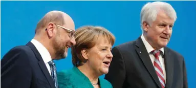  ??  ?? The Social Democratic Party’s now former leader Martin Schulz, Christian Democratic Union (CDU) leader and German Chancellor Angela Merkel and Christian Social Union (CSU) leader Horst Seehofer give a statement on the success of talks to form a new...