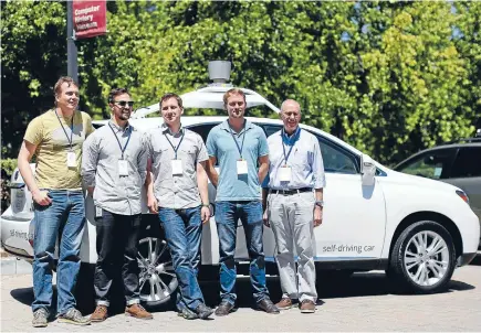  ?? Photo: Reuters ?? Hands-free: Chris Urmson, left, director of Google’s Self-Driving Car Project, and team members Brian Torcellini, Dmitri Dolgov, Andrew Chatham, and Ron Medford, who is director of safety for the project, pose in front of a self-driving car.