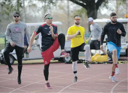  ?? PHELAN M. EBENHACK/THE ASSOCIATED PRESS ?? MLB players, from left, Carlos Gonzalez, Jose Lobaton, Ender Inciarte and Mauro Conde work out at the Coach Tom Shaw Performanc­e camp in Lake Buena Vista, Fla., an off-season camp that blends football and baseball training techniques.