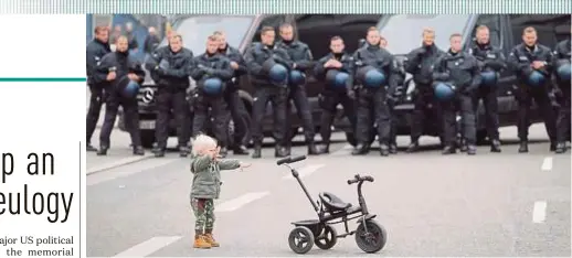  ?? EPA PIC ?? A child playing in front of police officers nearby a demonstrat­ion of the right-wing group ‘Pro Chemnitz’ in Chemnitz, Germany, on Saturday.