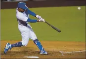  ?? ASHLEY LANDIS — THE ASSOCIATED PRESS ?? The Dodgers’ Mookie Betts flies out to right field during the third inning of the team’s game against the Angels on Friday.