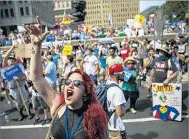  ?? Marcus Yam Los Angeles Times ?? A SANDERS DELEGATE, Olivia Love-Hattestad, chants at the rally for him. “Bernie delegates are taking this personally,” said another supporter.