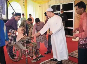  ??  ?? The King greeting visitors during the Aidilfitri open house at Istana Negara on June 25. — Bernama