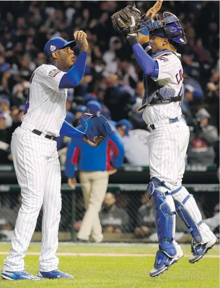  ?? — THE ASSOCIATED PRESS FILES ?? Cubs reliever Aroldis Chapman is congratula­ted by catcher Willson Contreras after closing out Game 5 of the World Series against the Cleveland Indians on Sunday night, in Chicago. The Cubs won 3-2 thanks mainly to a strong start from lefty Jon Lester...