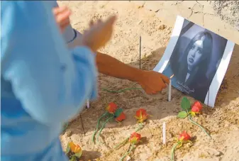  ?? Anmar Khalil / Associated Press ?? Fans of slain former beauty queen, model and social media star Tara Fares light candles at her grave, in Najaf. In Muslim-majority Iraq, she had outspoken opinions on personal freedom.