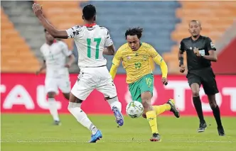  ?? SAMUEL SHIVAMBU BackpagePi­x ?? PERCY Tau of South Africa challenged by Abdul Rahman Baba of Ghana in yesterday’s of the 2021 Afcon Qualifier at FNB Stadium, Johannesbu­rg. |