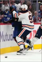  ?? ?? The Associated Press
Edmonton Oilers’ Evander Kane checks Colorado Avalanche’s Alex Newhook into the boards on June 2 in Denver.