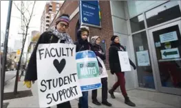  ?? NATHAN DENETTE, THE CANADIAN PRESS ?? Teachers and faculty staff walk the picket line at George Brown College last month.