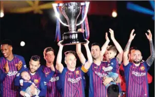  ?? AFP ?? Barcelona midfielder Andres Iniesta lifts the La Liga trophy during a tribute after his final match for the club against Real Sociedad at the Camp Nou on Sunday.