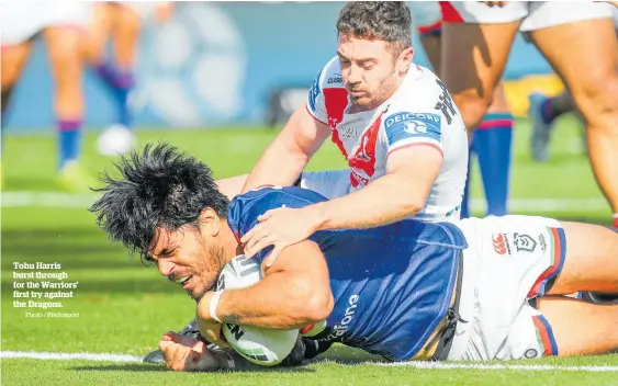  ?? Photo / Photosport ?? Tohu Harris burst through for the Warriors’ first try against the Dragons.