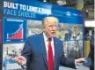  ?? Brendan Smialowski, AFP ?? President Donald Trump holds a mask as he speaks during a tour of the Ford Rawsonvill­e Plant in Michigan on May 21.