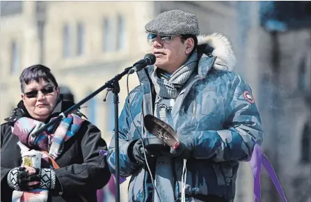  ?? JUSTIN TANG THE CANADIAN PRESS ?? Sixties Scoop survivor Mista Wasis holds smudge and an eagle feather as he speaks during a national solidarity rally.