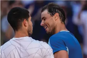  ?? The Associated Press ?? ■ Spain’s Rafael Nadal, right, congratula­tes Spain’s Carlos Alcaraz after their match at the Mutua Madrid Open Friday in Madrid.