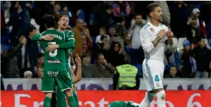  ?? Reuters ?? Leganes players celebrate as Sergio Ramos looks dejected after the Copa del Rey match. —