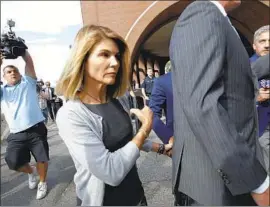  ?? LORI LOUGHLIN Steven Senne Associated Press ?? departs federal court in Boston in August 2019. The actress has reported to a federal prison in Dublin, Calif., to begin serving her sentence.