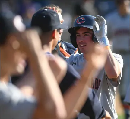  ?? PHOTO BY ANDY HOLZMAN ?? Chaminade's Carter Bennett is congratula­ted after scoring on a single by Isaiah Hearn in the sixth inning of Wednesday's win over Sierra Canyon.