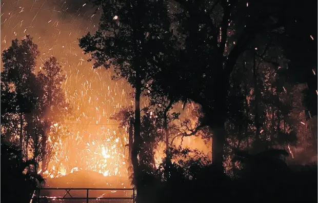  ?? SHANE TURPIN / SEELAVA. COM VIA THE ASSOCIATED PRESS ?? The eruption of Kilauea on Hawaii’s Big Island sent molten lava through forests and forced the evacuation of about 1,500 people from their homes.