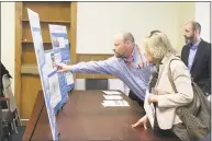  ?? Ignacio Laguarda / Hearst Connecticu­t Media ?? John Wyskiel, project engineer for the state Department of Transporta­tion, shows Stamford resident Dianne Walker the layout of the proposed parking garage for the Stamford Train Station during an open house at the station on Wednesday.