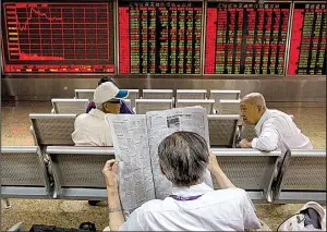  ?? AP/NG HAN GUAN ?? Investors wait for the start of afternoon trading at a brokerage in Beijing last month. China Investment Corp., China’s $800 billion sovereign wealth fund, is urging the United States to allow easier access to its market.