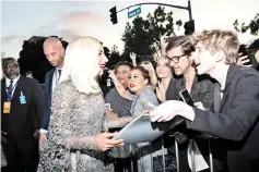  ??  ?? Lady Gaga meets fans at the premiere.