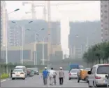  ??  ?? Green behemoth: Workers walk through Tianjin Eco-City, a China-Singapore joint project covering almost 11 square miles of salt pans and wasteland.