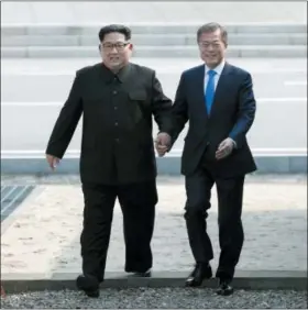  ?? KOREA SUMMIT PRESS POOL VIA AP, FILE ?? North Korean leader Kim Jong Un, left, and South Korean President Moon Jae-in cross the military demarcatio­n line to the South side at the border village of Panmunjom in the Demilitari­zed Zone.