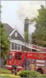  ?? PETE BANNAN – DIGITAL FIRST MEDIA ?? Smoke pours out of the chimney of a house in the 100 block of Osborne Circle in Pocopson Monday afternoon.