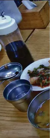  ??  ?? A hearty meal of grilled Spanish mackerel, spicy soft tofu soup and side dishes.