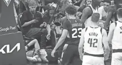  ?? ROB SCHUMACHER/THE REPUBLIC ?? Suns guard Devin Booker lies on the floor after a hard foul during Tuesday’s game against the Mavericks in Phoenix.