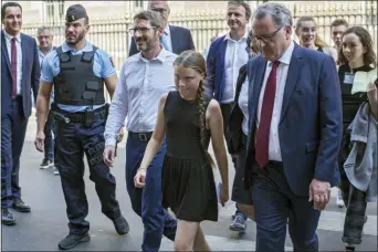  ?? RAFAEL YAGHOBZADE­H — THE ASSOCIATED PRESS ?? Swedish climate activist Greta Thunberg, centre, arrives for a meeting in the French National Assembly, in Paris, France, Tuesdays.