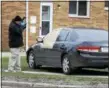  ?? ASSOCIATED PRESS FILE ?? An Ohio Bureau of Criminal Investigat­ion investigat­or take pictures of a vehicle after a shooting March 13 in Euclid.