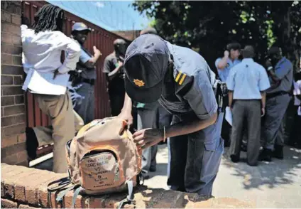  ?? Photo: Lauren Mulligan/gallo Images ?? On guard: Police search learners’ bags for illegal substances, alcohol and weapons at a high school in Johannesbu­rg.