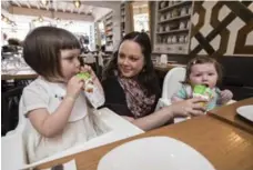  ?? BERNARD WEIL/TORONTO STAR FILE PHOTO ?? Kristen Thompson feeds her children Isla, left, 3 and Polly, 7 months, at a PC Babyliciou­s event held at Tabule Restaurant.