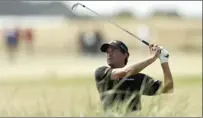  ?? AP photo ?? Kevin Kisner plays out of the rough on the 18th hole during the first round of the British Open on Thursday. Kisner shot a 5-under 66.