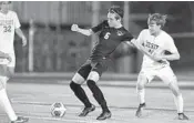  ?? MICHAEL LAUGHLIN/SUN SENTINEL ?? American Heritage’s Anibel Morral-Rosales is held by Jesuit’s Boyd Merrill during the state semifinal Saturday.