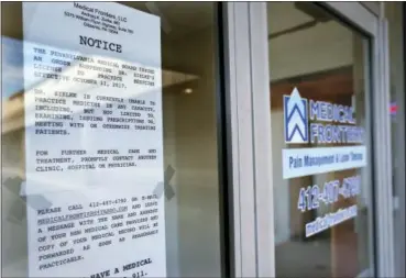  ?? KEITH SRAKOCIC — THE ASSOCIATED PRESS ?? In this photo, a notice stating the license to practice medicine for Dr. Andrzej Zielke has been suspended, is posted on the door at the closed Medical Frontiers office in Gibsonia, Pa. The Justice Department is giving federal prosecutor­s in 12 regions...