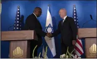  ?? (AP/Maya Alleruzzo) ?? U.S. Secretary of Defense Lloyd Austin (left) shakes hands with his Israeli counterpar­t, Minister of Defence Yoav Gallant at a joint statement following their meeting Thursday at Ben Gurion Internatio­nal Airport.