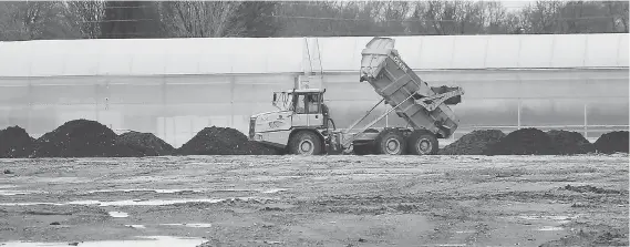  ?? DAN JANISSE ?? A dump truck unloads dirt on Aphria property in Leamington on Friday. The medical cannabis grower is working on a multimilli­on-dollar expansion.