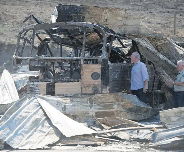  ?? — THE CANADIAN PRESS ?? Premier John Horgan, touring Cache Creek Monday, said the evacuation response in Kamloops was ‘heartwarmi­ng.’