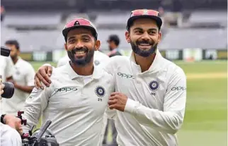  ?? -AFP ?? CELEBRATE: India’s captain Virat Kohli, right, and Ajinkya Rahane, left, celebrate on the final day of the third cricket Test match between Australia and India in Melbourne yesterday.