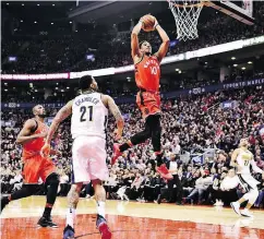  ?? FRANK GUNN / THE CANADIAN PRESS ?? Raptors guard DeMar DeRozan scores as Denver Nuggets forward Wilson Chandler looks on.