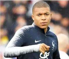  ?? — AFP photo ?? Mbappe looks on during a training session in Guingamp, western France.
