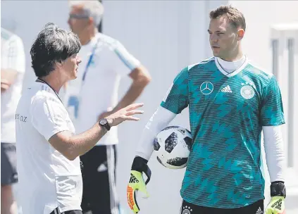  ?? Picture: AFP ?? BRAINSTRUS­T. German coach Joachim Loew and captain Manuel Neuer in deep discussion during a training session at the Olympic Park Arena in Sochi this week.