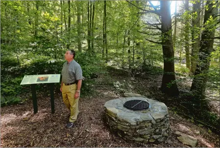  ?? DANA JENSEN/THE DAY ?? Frank Manfredi, chairman of the Ellis Walter Ruley Project Committee, walks in the area of the partially rebuilt well Wednesday while showing the work that has been done to create the Ellis Walter Ruley Memorial Park on Ruley’s homestead property in Norwich.