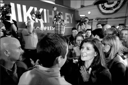  ?? ROBERT F. BUKATY / ASSOCIATED PRESS ?? Republican presidenti­al candidate Nikki Haley, right, greets voters Feb. 16 at a town hall campaign event in Exeter, N.H.