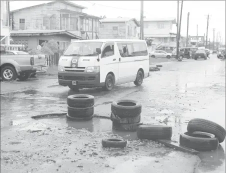  ?? News by Keno George) Stabroek (Photo ?? Residents last week placed old tyres around a large pothole on Norton Street, Lodge in a bid to prevent vehicles from dropping in. It was related to on Thursday that the large pothole had been in such a state for more than a week.