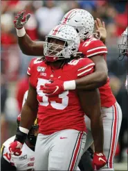  ?? JAY LAPRETE — THE ASSOCIATED PRESS ?? Ohio State defensive lineman Davon Hamilton, front, celebrates his sack against Maryland with teammate running back Zach Harrison during the first half of an NCAA college football game, Saturday.