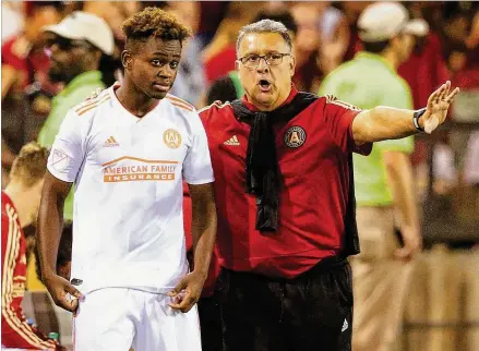  ?? CURTIS COMPTON / CCOMPTON@AJC.COM ?? Atlanta United head coach Gerardo Martino coaches up midfielder Chris Goslin against Charleston Battery in June. Today is Martino’s last chance to emphatical­ly validate his decision to coach an MLS expansion franchise.