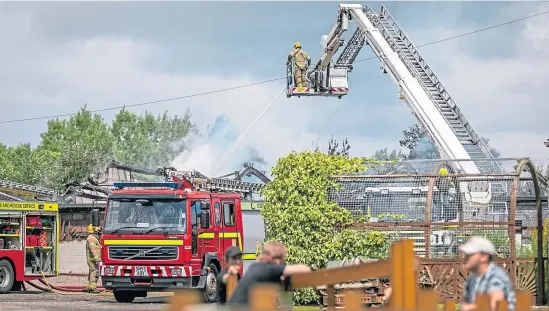  ?? Picture: Steve Brown. ?? Firefighte­rs in attendance putting out the blaze in the soft play area at Fife Zoo yesterday afternoon.